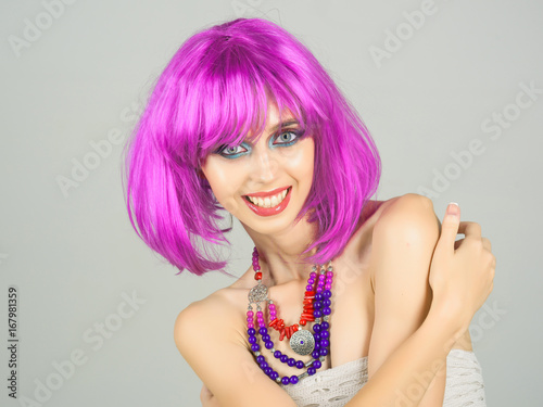 woman smiling with violet hair wig and fashionable makeup