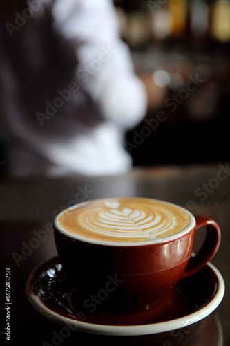 Cappuccino coffee on coffee bar in dark tone