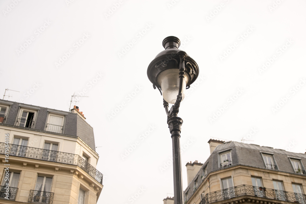 Detail of old street lamp in a street in Paris