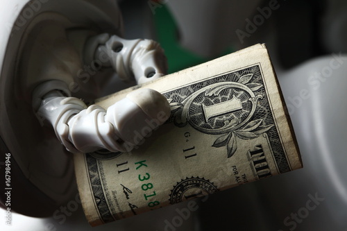 Money in robot hand represent finance and technology concept related idea.