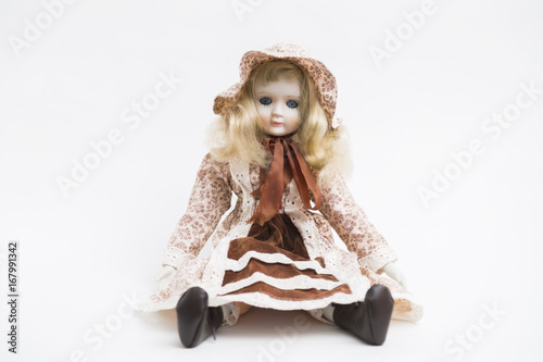 Ceramic porcelain handmade blond doll with textile hat and brown dress