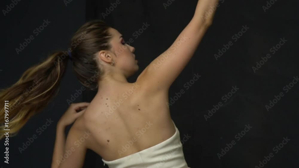 Sensual girl posing in studio with curtained dark cloth Sensual girl posing in studio with curtained dark cloth