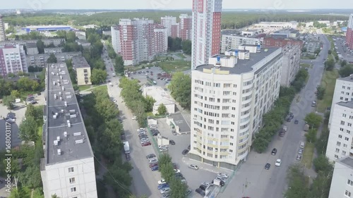 Aerial view on sleeping neighborhood in district with new houses. Business and culture concept - panoramic district skyline bird eye aerial view under dramatic sun and morning blue cloudy sky photo