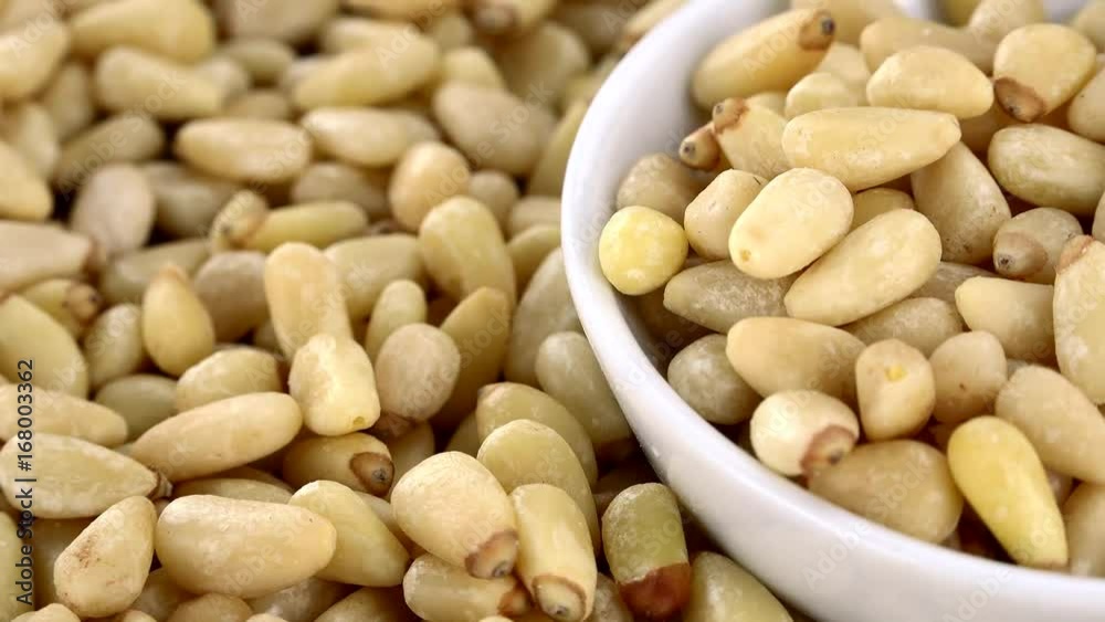 Pine Nuts on a rotating wooden plate (seamless loopable; 4K) Pine Nuts on a rotating wooden plate (seamless loopable; 4K)