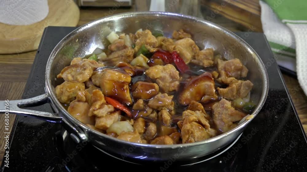 Kung Pao chicken simmering in a frying pan Kung Pao chicken simmering in a frying pan