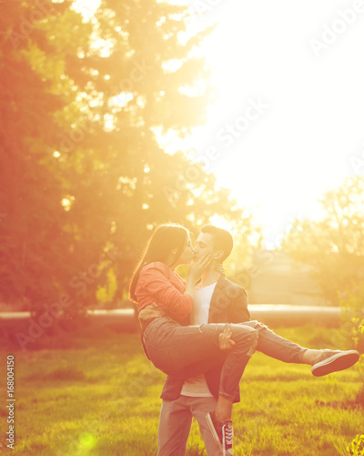 Dating couples in park at sunset