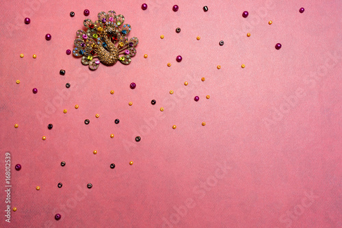 Fotografering postcard pattern brooch and beads/postcard pattern brooch and beads on a pink ba