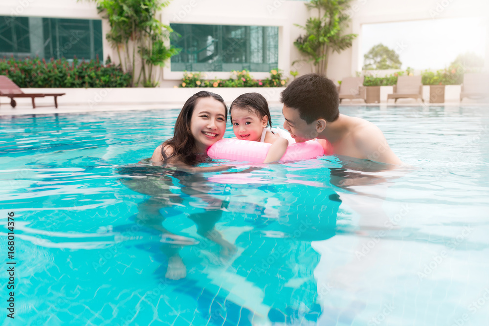 Fototapeta premium Happy family in swimming pool. Summer holidays and vacation concept