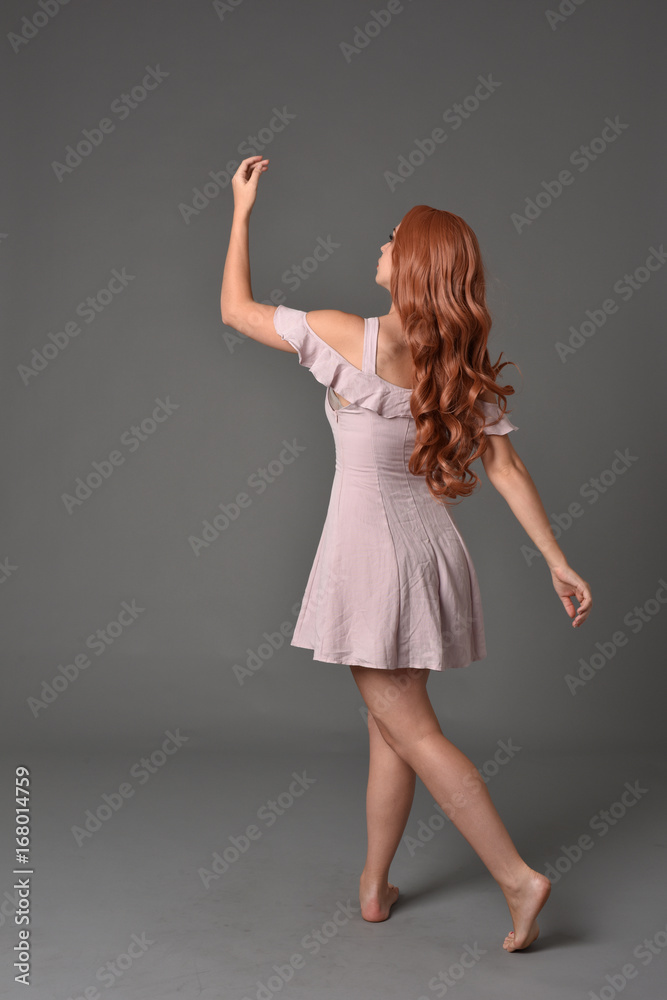 full length portrait of pr a pretty girl wearing simple purple dress, standing pose against a grey background full length portrait of pr a pretty girl wearing simple purple dress, standing pose against a grey background