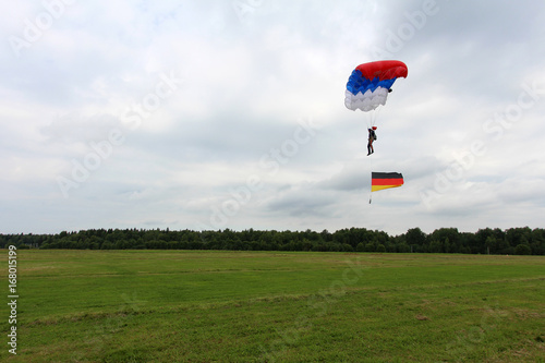 Skydiver with german flag is landing