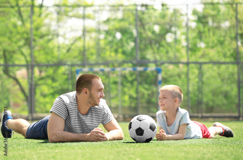 Father and son with ball ly...