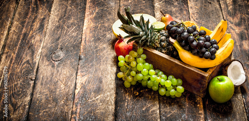 Various ripe fruits in a wooden box.