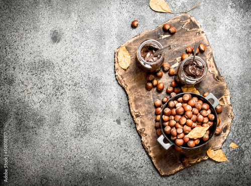 nut butter from hazelnuts and chocolate. On rustic background. © Artem Shadrin