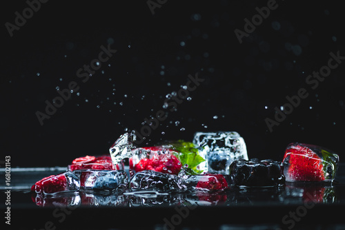 Fototapeta Naklejka Na Ścianę i Meble -  frozen fruits in ice cubes