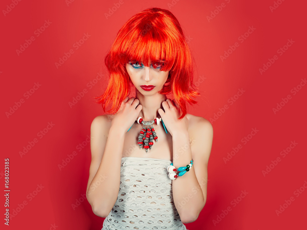 Woman in red wig with fashionable makeup.