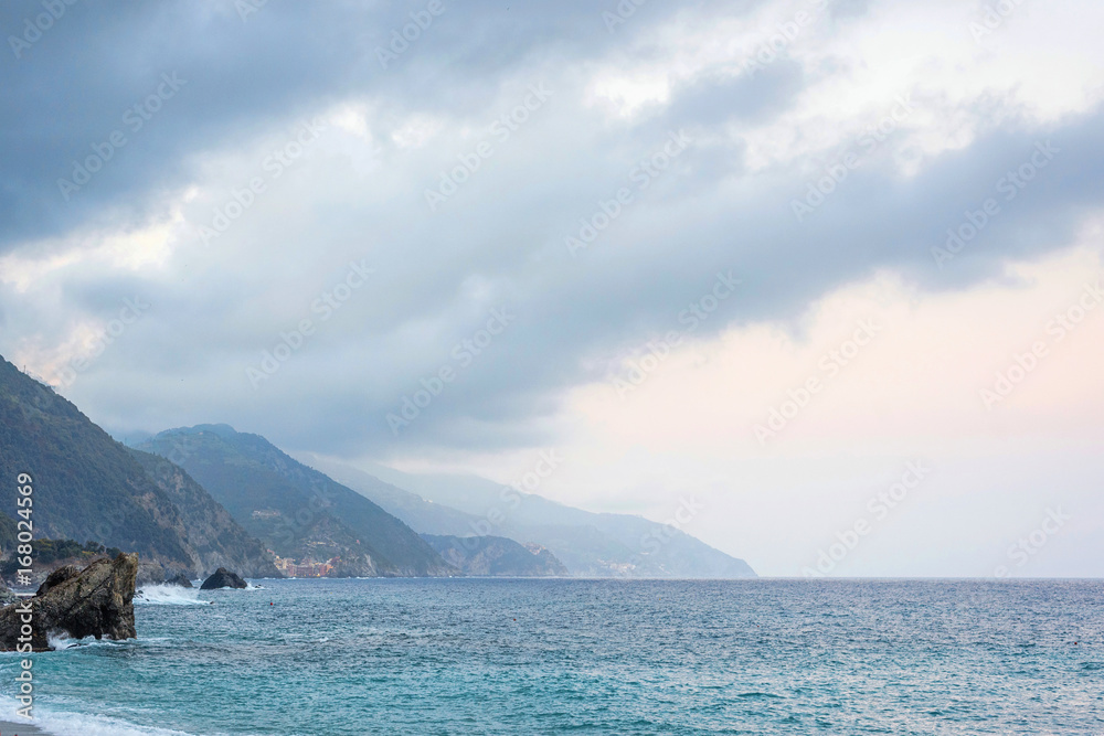 Beautiful view to Monterosso al Mare mountains and blue sea in cloudy day. Italy, Cinque Terre