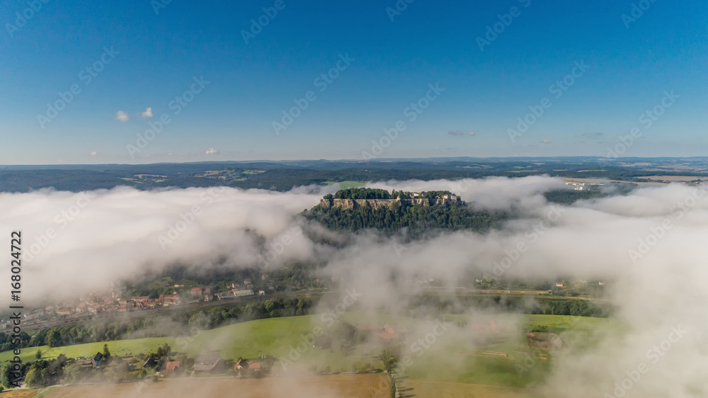 Aerial view on Koenigstein fortress in the morning with a mist in the valley of the River Elbe