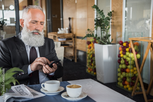 businessman using smartphone in restaurant