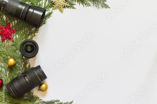 Lenses for reflex camera and Christmas decorations on a white  background photo