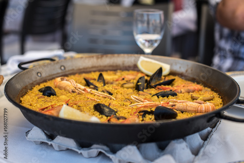 Photography Paella recipe for two in traditional pan, recipe from Mediterranean