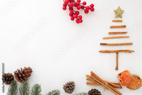 Christmas background - Christmas tree made of cinnamon with decoration on white background. Holiday concept.  Creative flat lay, top view design.