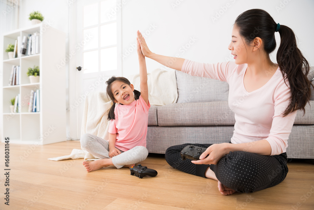 daughter and elegant mother raised hands clapping daughter and elegant mother raised hands clapping