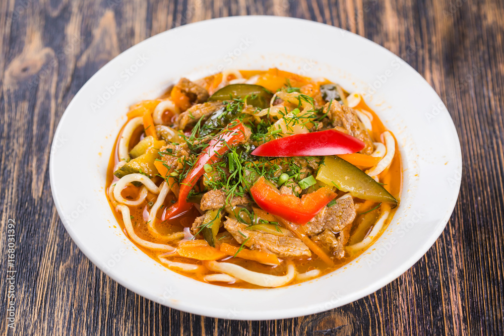 Close-up of traditional asian noodle lagman with vegetables and meat Close-up of traditional asian noodle lagman with vegetables and meat