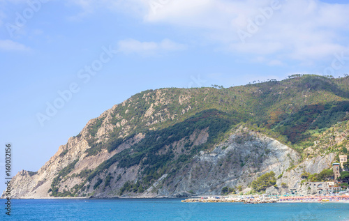 Daylight sunny day view to blue sea and green mountains. Monterosso al Mare, Italy, Cinque Terre.