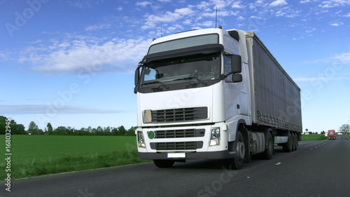 White Truck with Semi Trailer Driving on the Rural Road.