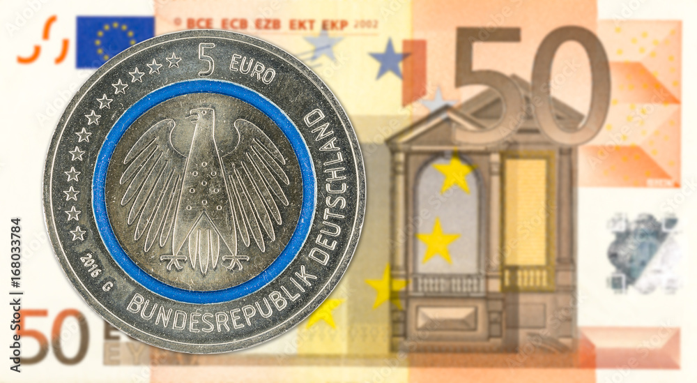 5 euro coins against 50 euro bank note obverse