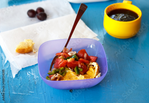 Healthy mixed saladserved with tea and toast on an exotic bright turquoise blue picnic table with copy space photo