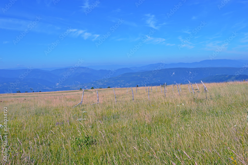 Natural mountain landscape with sky and grass