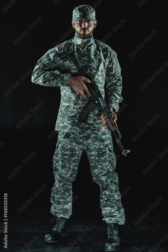 soldier in military uniform with rifle