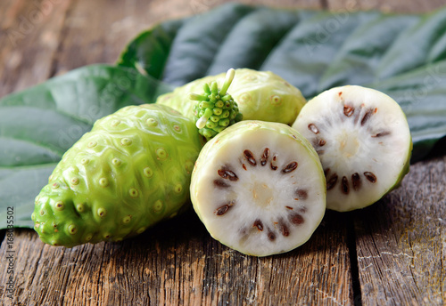 noni fruit on wooden background