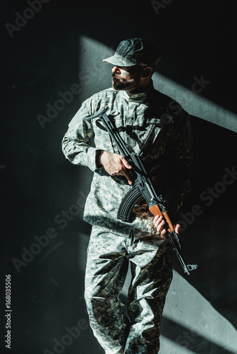 soldier in military uniform with rifle