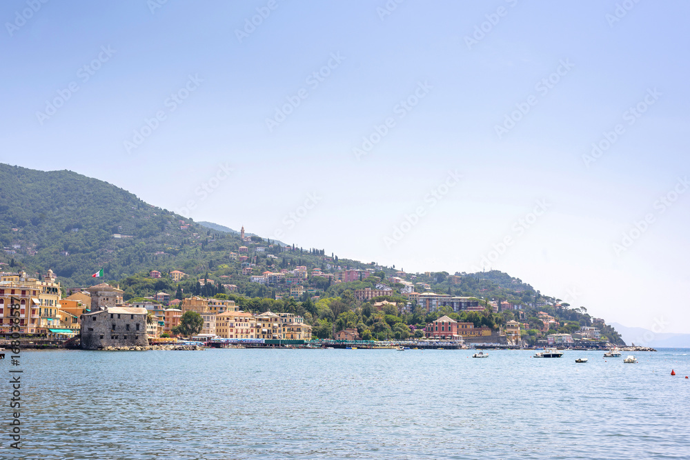 Daylight view to mountains, blue sea and city of Rapallo, Italy.
