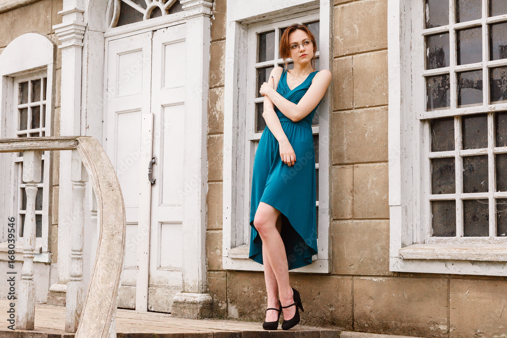 Obraz premium elegant young woman on stair of an old palace