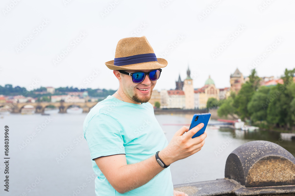 Young hipster man using mobile smart phone outdoor
