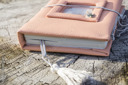 Handmade pink leather notebook with decoration like shaker with paillettes and tassel photo