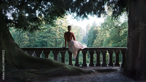 girl sitting on balustrade enjoying view