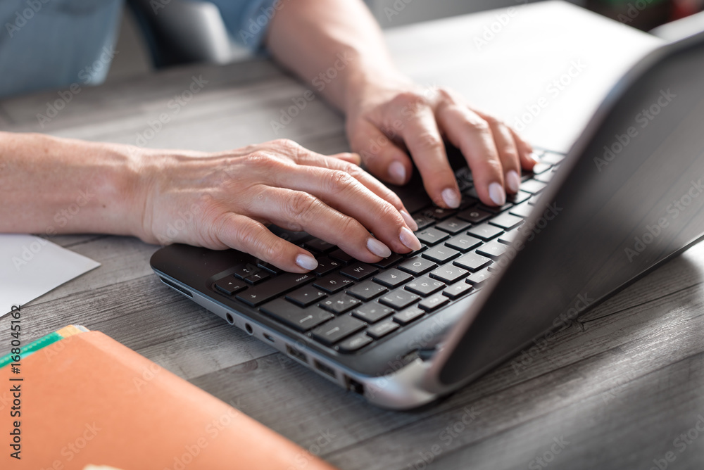Female hands using a laptop Female hands using a laptop