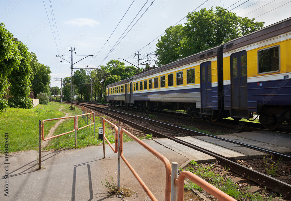 Train passing a railway crossing. Train passing a railway crossing.