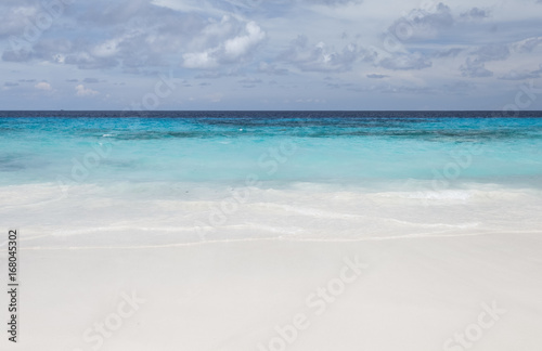 White beach sand and beautiful blue sea and sky
