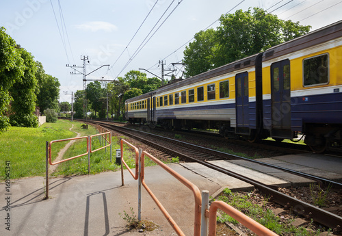 Train passing a railway crossing.