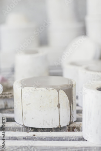 Closeup of a ceramic clay mould filled with slip