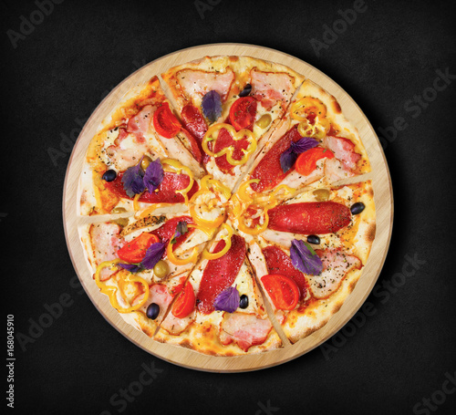 Pizza with salami, ham and bacon on a black background. Visit my page. You will be able to find an image for every pizza sold in your cafe or restaurant.