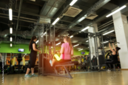 Blurred picture of exercising females in gym