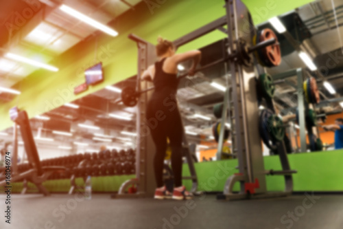 Blurred picture of exercising female in gym