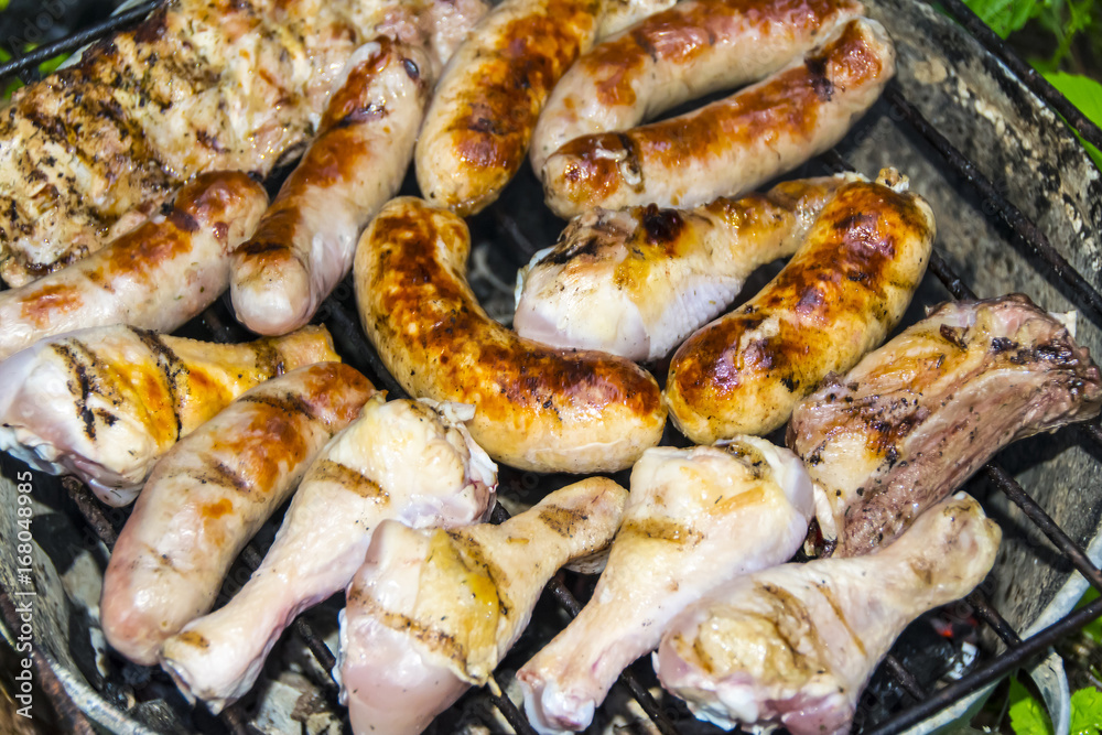Sausages pork ribs chicken legs on the grill barbecue Sausages pork ribs chicken legs on the grill barbecue