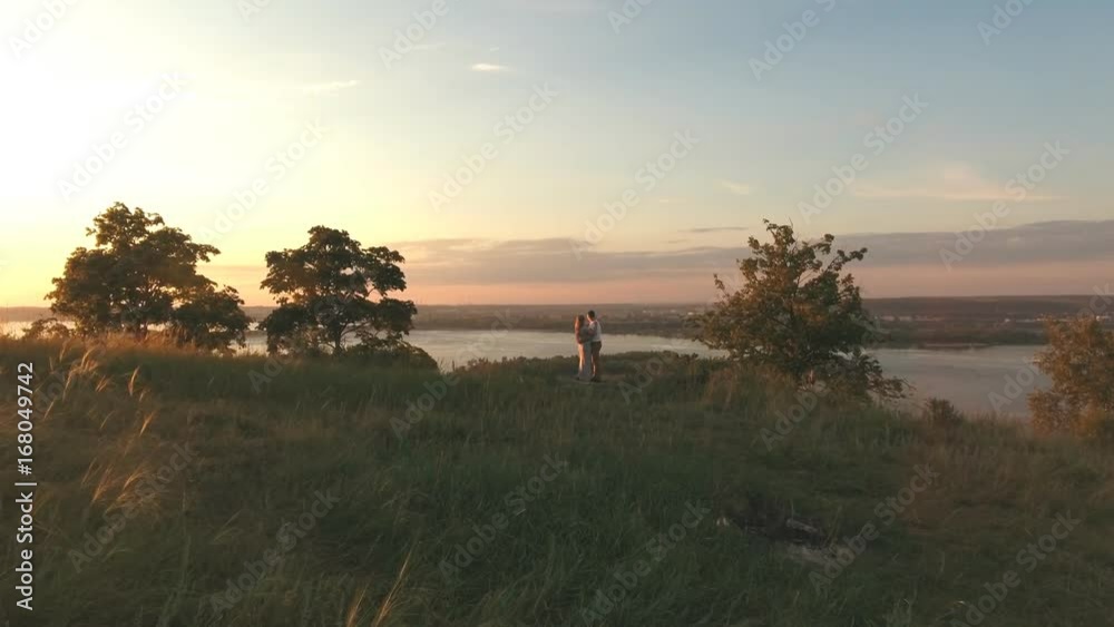 happy couple hugging at the edge of the cliff, aerial shoting happy couple hugging at the edge of the cliff, aerial shoting